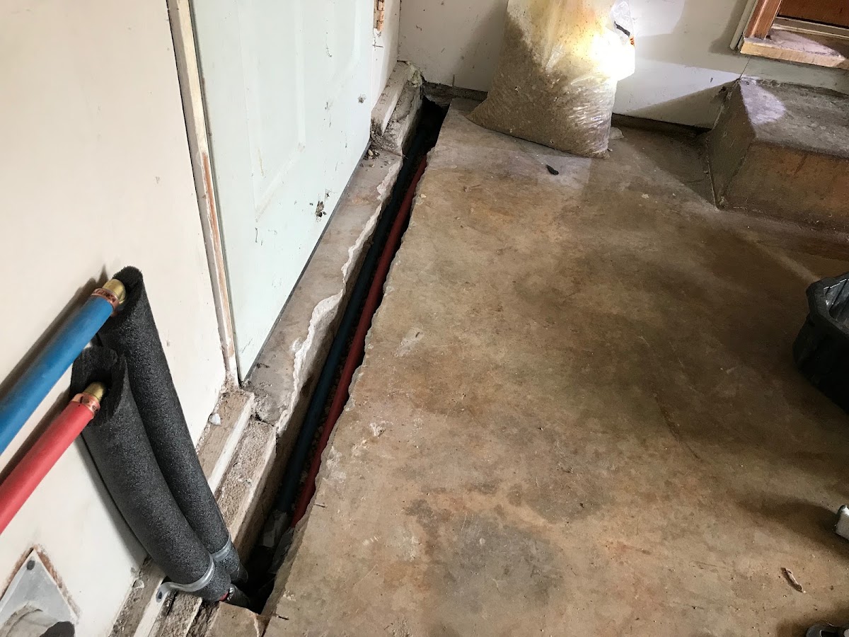 PEX repipe run through a trench cut into the slab